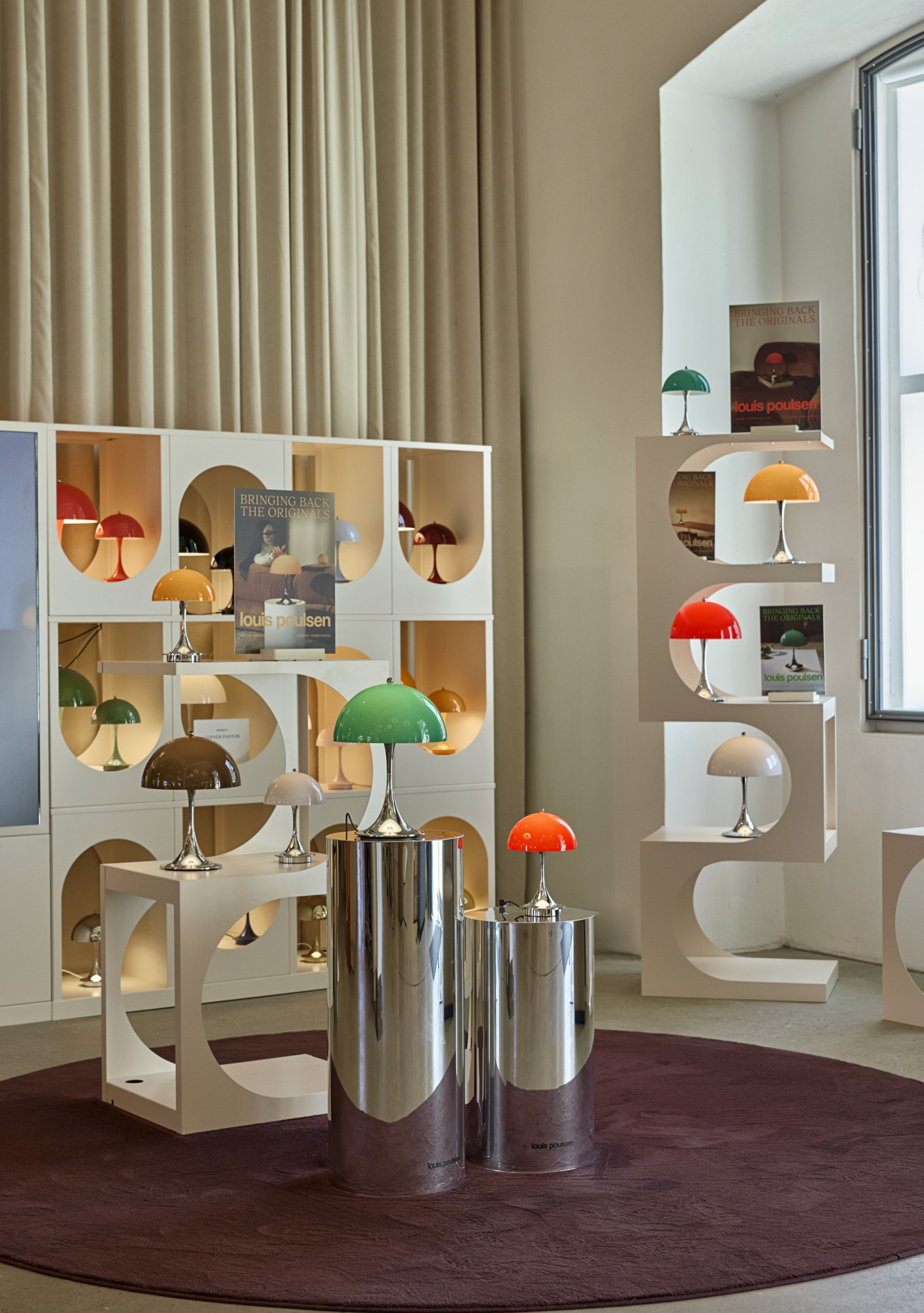 Panthella table lamps in multiple colours displayed inside the Louis Poulsen Copenhagen showroom, © 2025 Louis Poulsen.