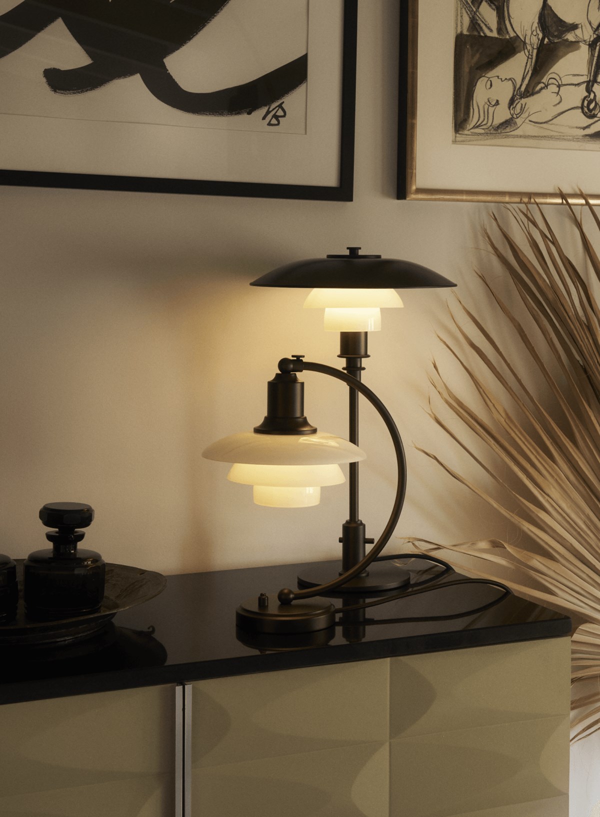 PH Aged Brass Opal table lamps on a coffee table in a chic interior, © 2025 Louis Poulsen."