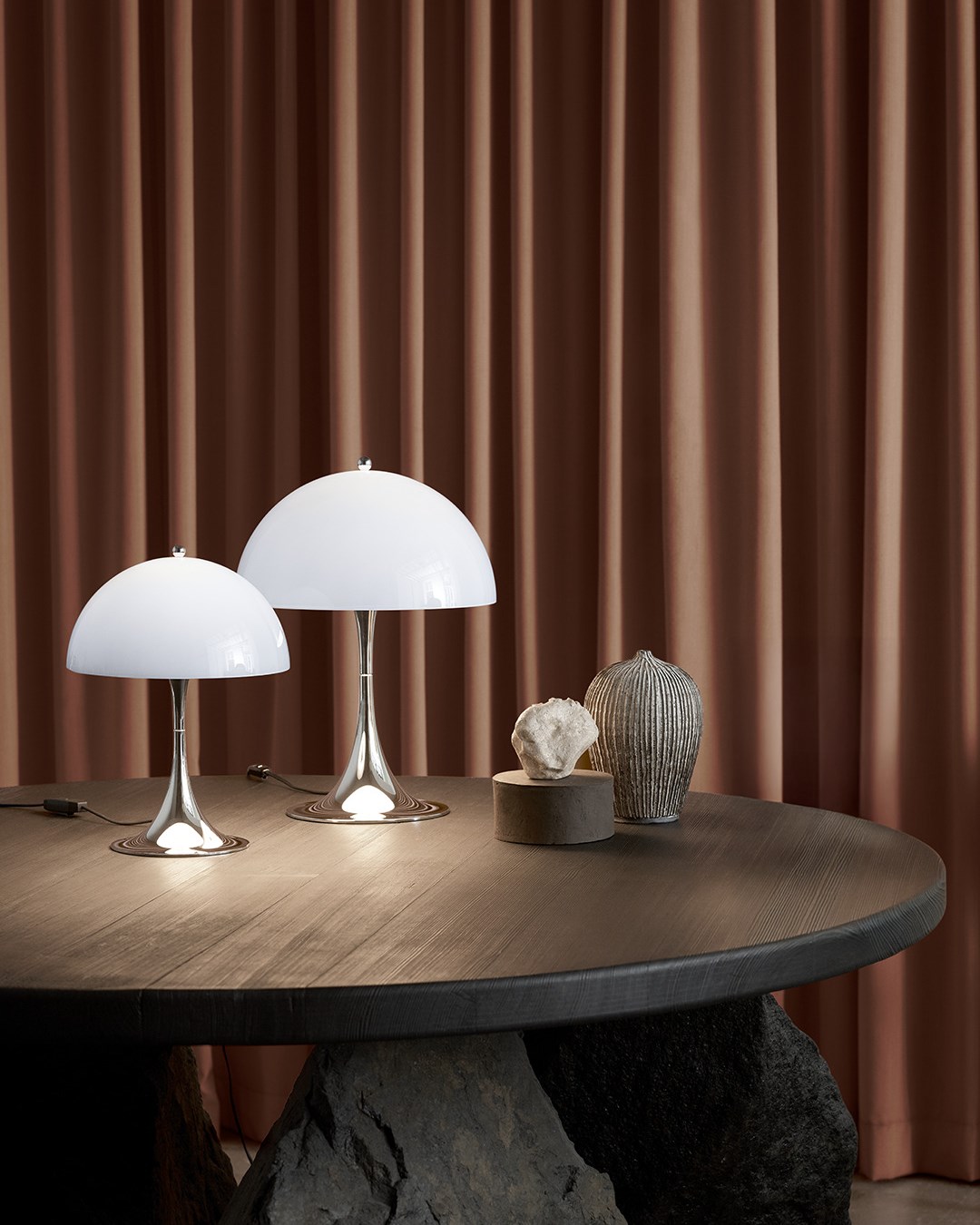 Panthella 250 + 320 Chrome Blue on a dark wooden table. 