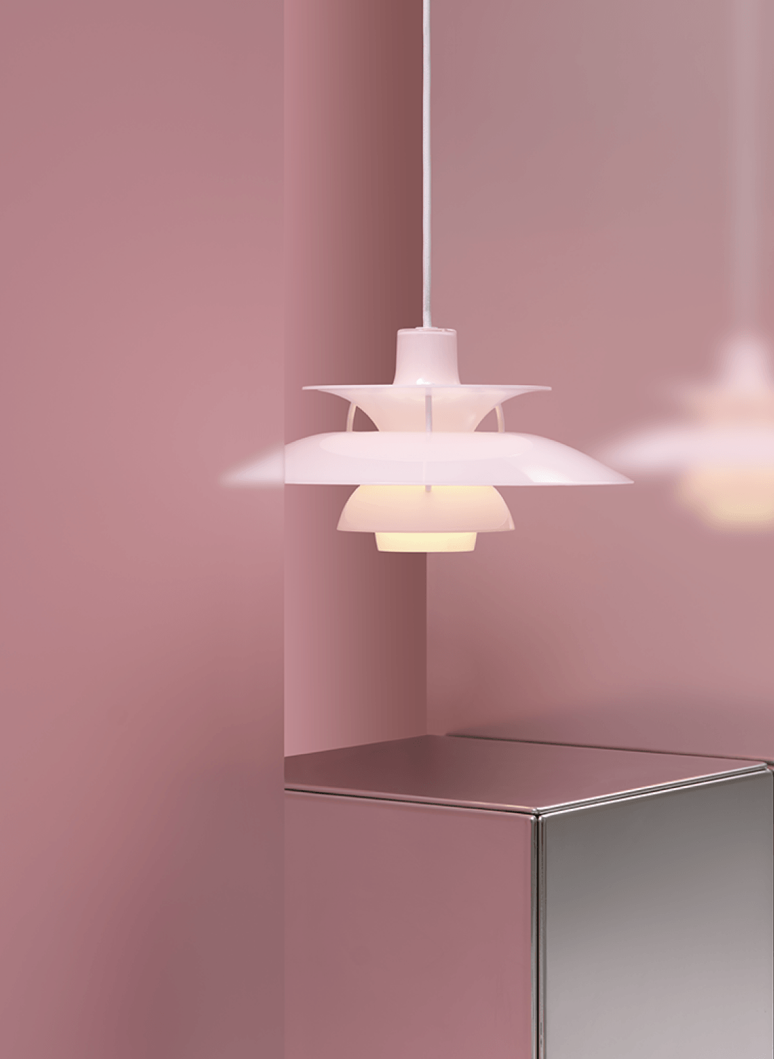PH 5 Opal in Pale Rose above a metal pedestal in a pink interior, © 2025 Louis Poulsen.