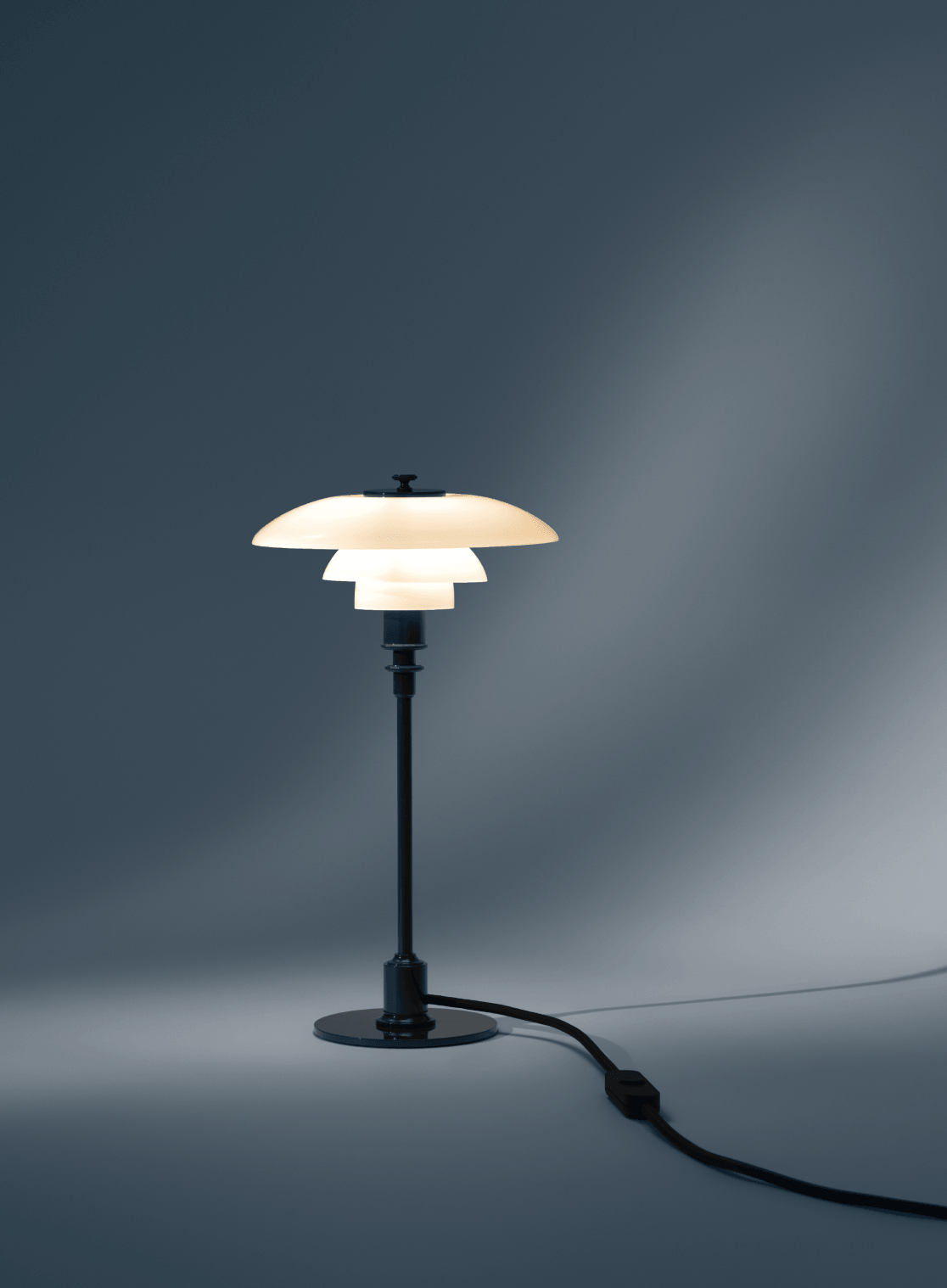 PH 2/1 Table Lamp in Deep Blue with illuminated opal glass shades, © 2025 Louis Poulsen.